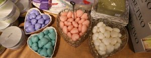 heart shaped bowls of heart shaped soaps in purple, blue, pink and white on display at Uncommon Scents at the Meridian